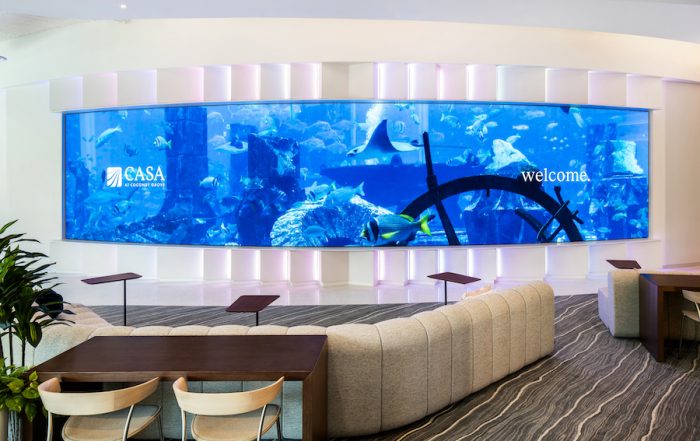 A large curved video wall that says “Welcome.”
